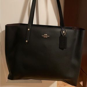 Like new Coach pebble leather black and gold zip top tote with tag. Used once.